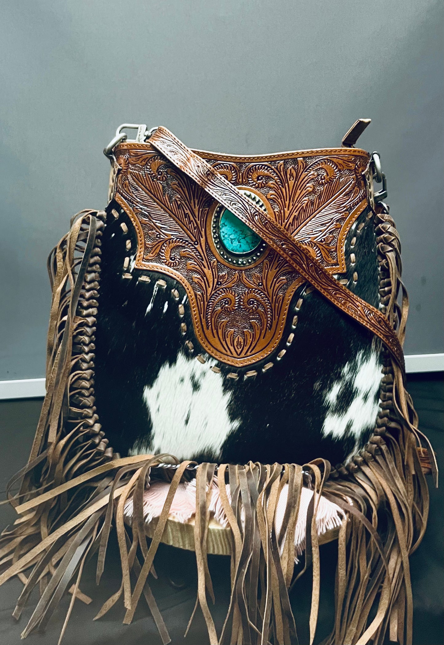 Cow hide purse with fringe and stone detail